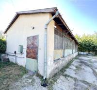 Industrial building in Marcelová, warehouses and halls, surrounded by vegetation.