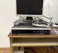 Computer with monitor and device on a shelf in the warehouse and hall.