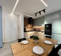 Kitchen in the Holiday Apartment with a dining table, brick cladding, and modern appliances.