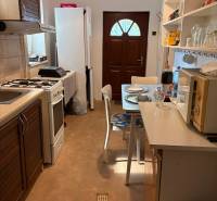 Kitchen in a family house with a dining table, appliances, and storage spaces.