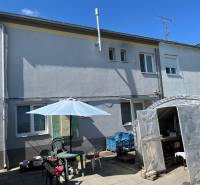 A family house in Komárno with a yard, seating area, and enclosed shelter.