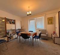 Dining room in a family house with a dining table, chairs, and furniture.