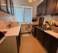 A kitchen in a family house with wooden cabinets and appliances.