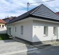 A family house in Turč. Kľačany, Martin, with light plaster, a paved walkway, and a small lawn.