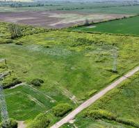 Landscape in Zemplínske Kopčany with agricultural and forest land, power lines, road.