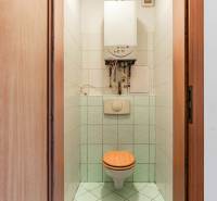 Bathroom with toilet and boiler in a 2-room apartment, tiled.