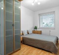Bedroom in a 2-room apartment with a double bed, built-in wardrobe, and dresser.