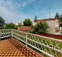 The balcony of a family house on Božena Němcová Street in Komárno with a view of the garden.
