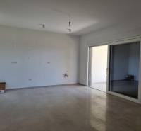 Spacious interior of a new 4-room apartment with large glass doors and tiling.
