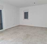 An empty room with light walls and tiles in a 4-room apartment.