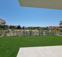 A garden at a 3-room apartment in Vodice, with a view of the surrounding buildings and greenery.