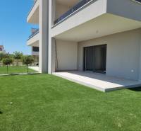 Exterior of a 3-bedroom apartment in Vodice with a lawn and terrace in the Croatian scenery.