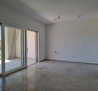 A spacious living room with a large window in a 3-room apartment.