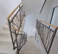A staircase with a metal railing in a 4-room apartment.