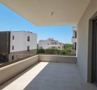 A balcony with a view of neighboring buildings in Vodice offers a space for relaxation.