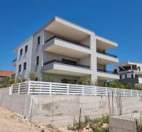 The exterior of a 4-room apartment in the city of Vodice shows a modern new building.