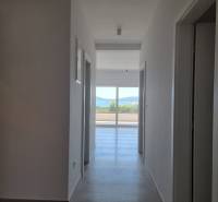 Bathroom in a 4-room apartment with a hallway and a view of the balcony.