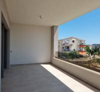 A balcony in a 4-room apartment in Vodice with a view of the surrounding buildings and greenery.