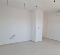 An empty room in a 4-room apartment with spotlights and air conditioning.