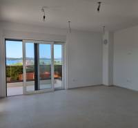 Spacious interior of a 4-room apartment with a view of the sea through large windows.