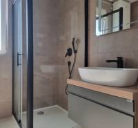 A bathroom with a shower and a sink in a 4-room apartment.