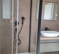 A bathroom with a shower and a sink in a 4-room apartment.