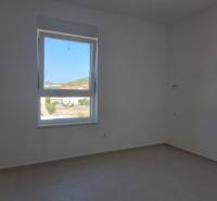 Bright room with a window, neutral walls in a 4-room apartment.