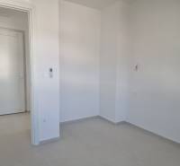 An empty room with white walls and a gray floor in a 4-room apartment.