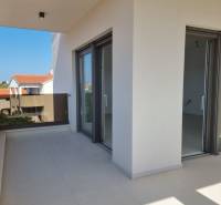 The balcony of a 4-room apartment in Vodice with a view of the roofs of surrounding buildings.