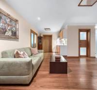 Living room in a family house with a sofa, table, and an art painting on the wall.