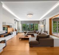 Spacious living room with a comfortable sofa set and a view of the garden in a family house.