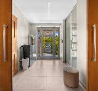 Interior of a family house with a hallway, glass doors, and tiles.