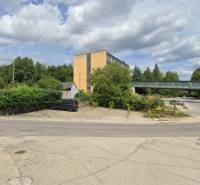 The intersection on Štrajková Street in Handlová, surrounded by greenery and industrial buildings. Land - commercial.