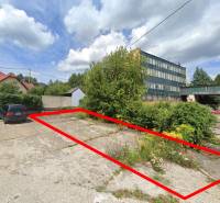 Commercial land in Handlová on Štrajková, next to the parking lot and administrative buildings.