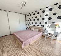 Bedroom in a 2-room apartment with a bed, built-in wardrobe, and dressing table.