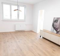 A bright room in a 2-room apartment with wooden flooring and decoration.
