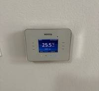 The digital thermostat displays the current temperature in a 2-room apartment.