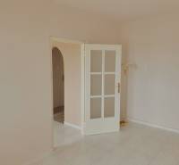 Tiling in a 3-room apartment, white doors with glazing, and a floor lamp.