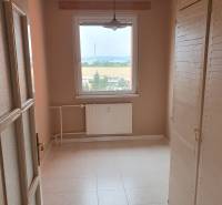 A small room in a 3-room apartment, wardrobes, window with a view, radiator.