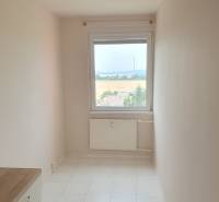 Narrow room with a window and tiled floor in a 3-room apartment.