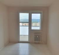A room in a 3-room apartment with tiles, a radiator, and a balcony door.