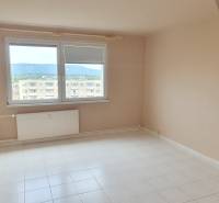 A room in a 3-room apartment with a white floor and a large window with a view.