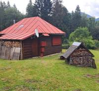 A cottage in Nižné Matejkovo in Ružomberok surrounded by forests with a wood storage.