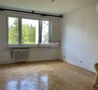 A room with a light parquet floor and a large window in a 3-room apartment.
