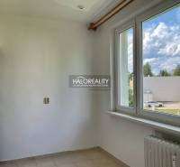 Interior of a 3-room apartment with white walls and a view from the window of Zvolen.
