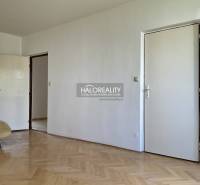 A room in a 3-room apartment with parquet flooring and white doors.
