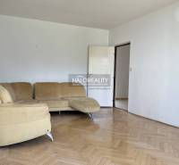 Living room in a 3-room apartment with a beige sofa and parquet flooring.