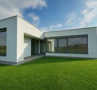 A family house in Kostolište on Martina Benku Street with a lawn and large windows.