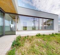 Family house in Kostolište on Martina Benku Street with a glass terrace and garden.