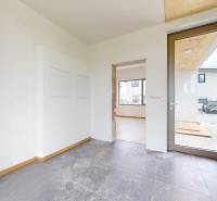Entrance hall in a family house with glass doors and light-colored walls.